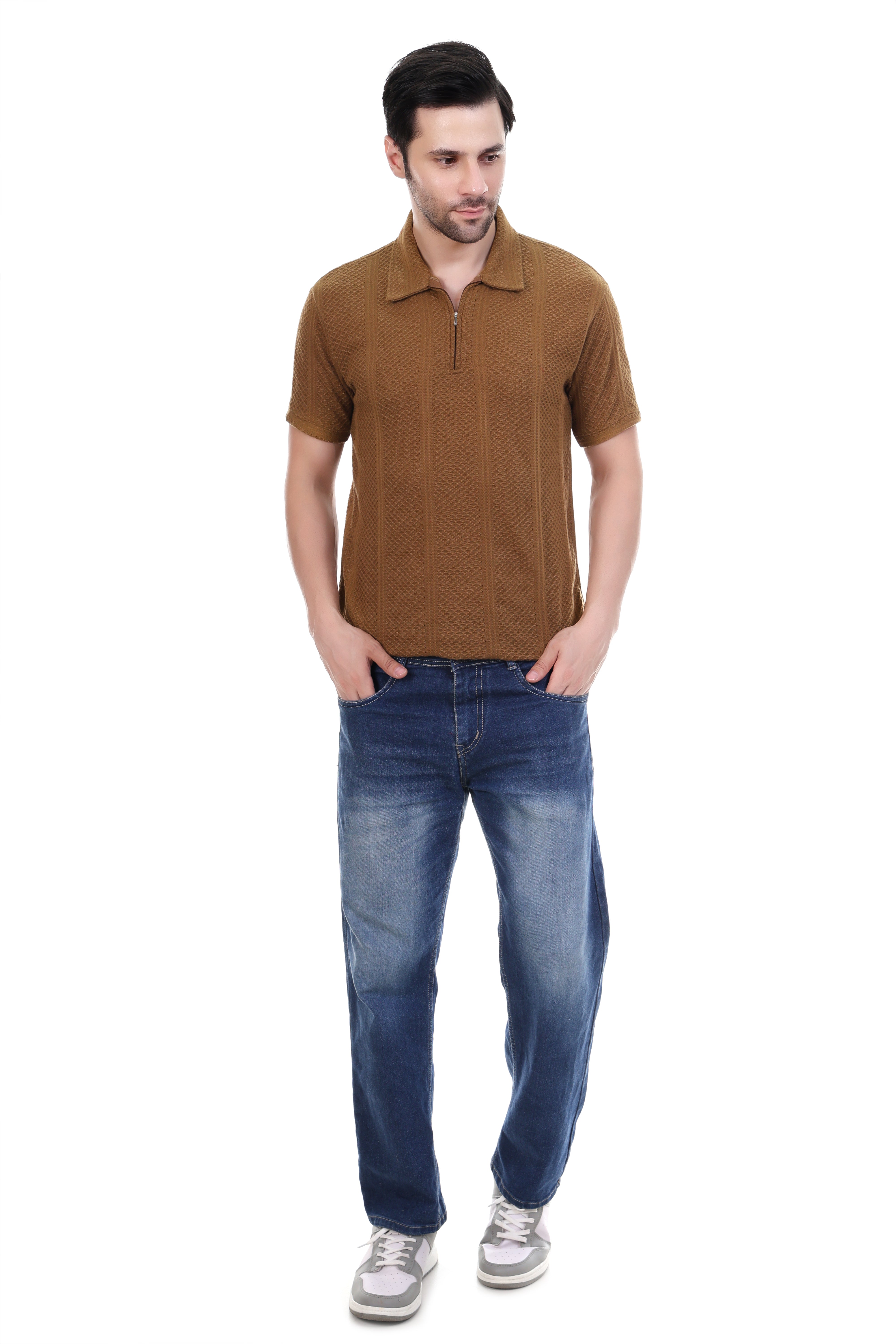 Man wearing a brown polo shirt and blue jeans on a white background