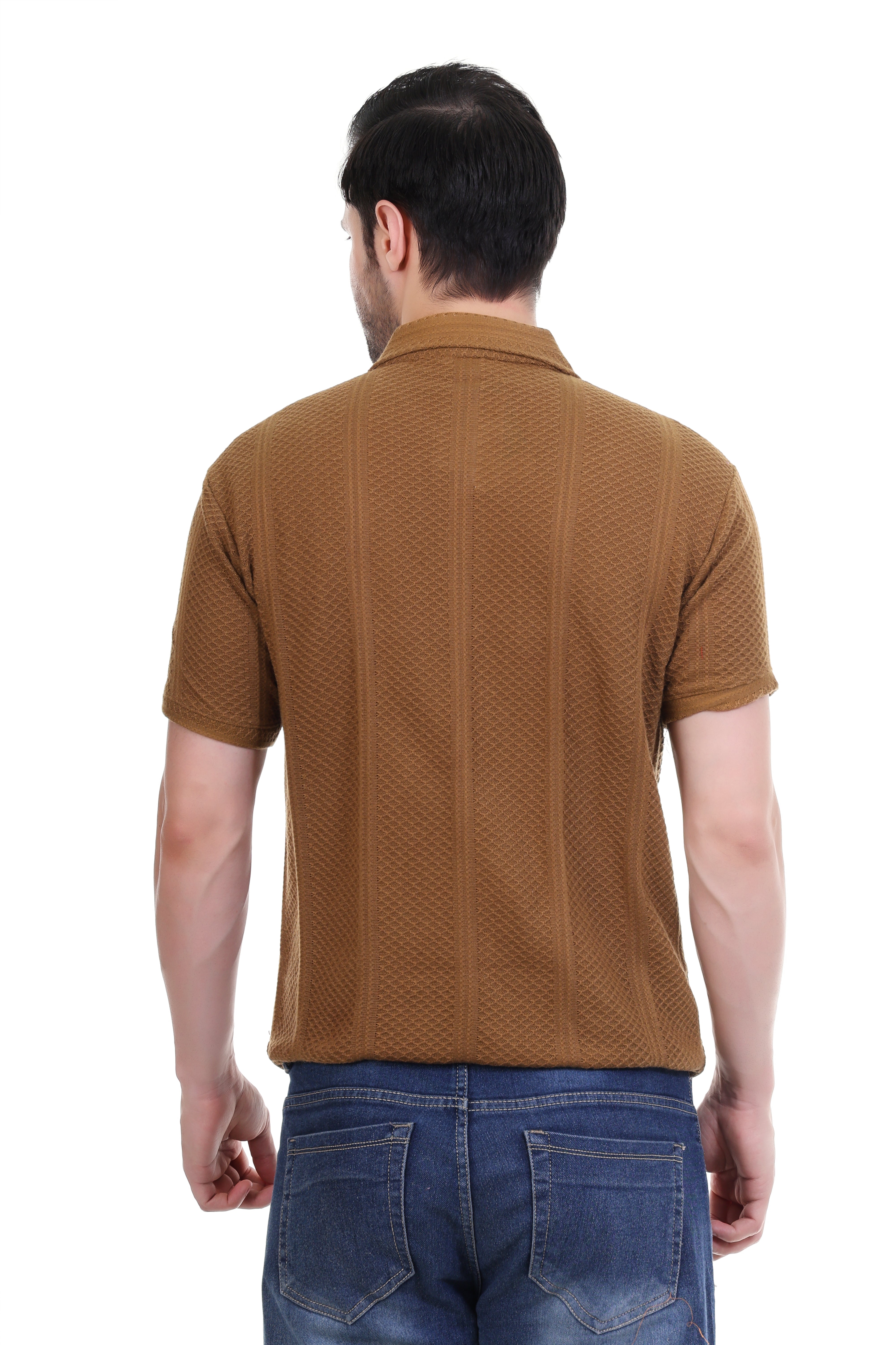 Man wearing a brown textured polo shirt and blue jeans on a white background