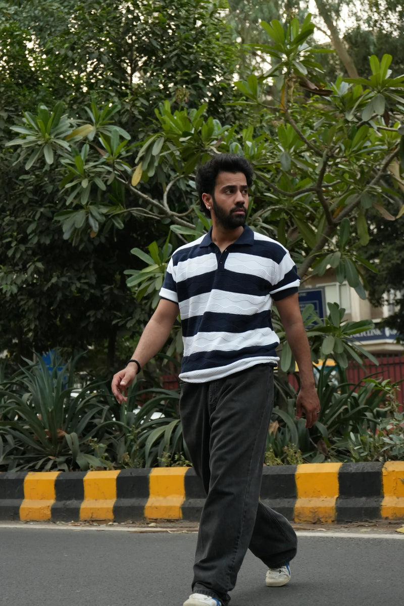 Man walking on a road with Striped tshirt