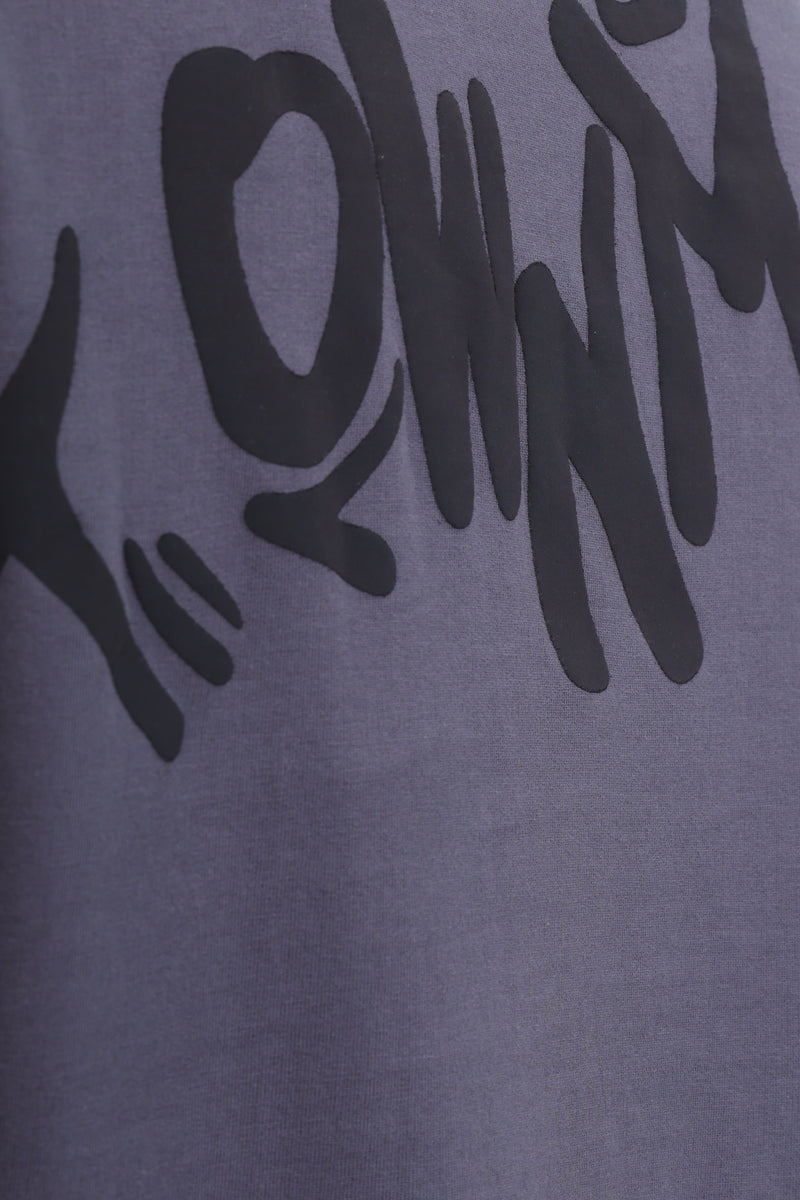 Gray t-shirt with black text and graphics on a gray background