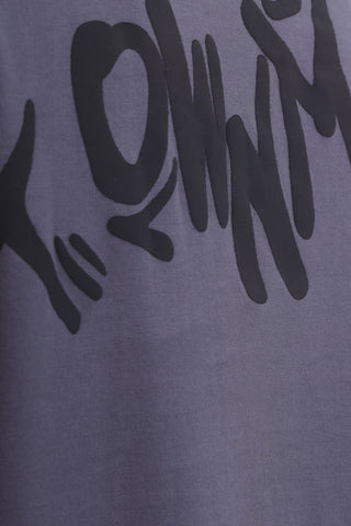 Gray t-shirt with black text and graphics on a gray background