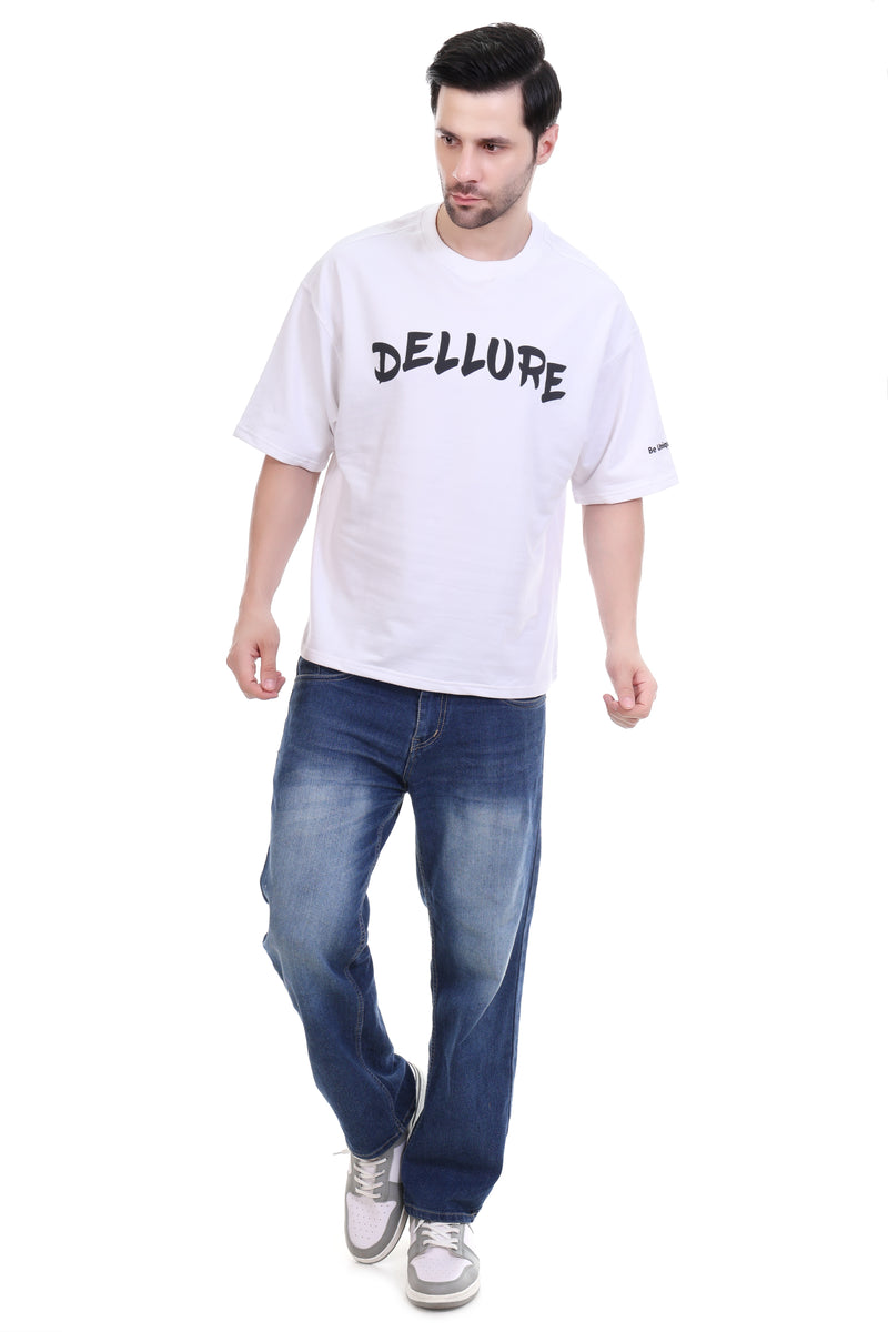 Man wearing a white t-shirt with 'DELLURE' text and blue jeans on a white background